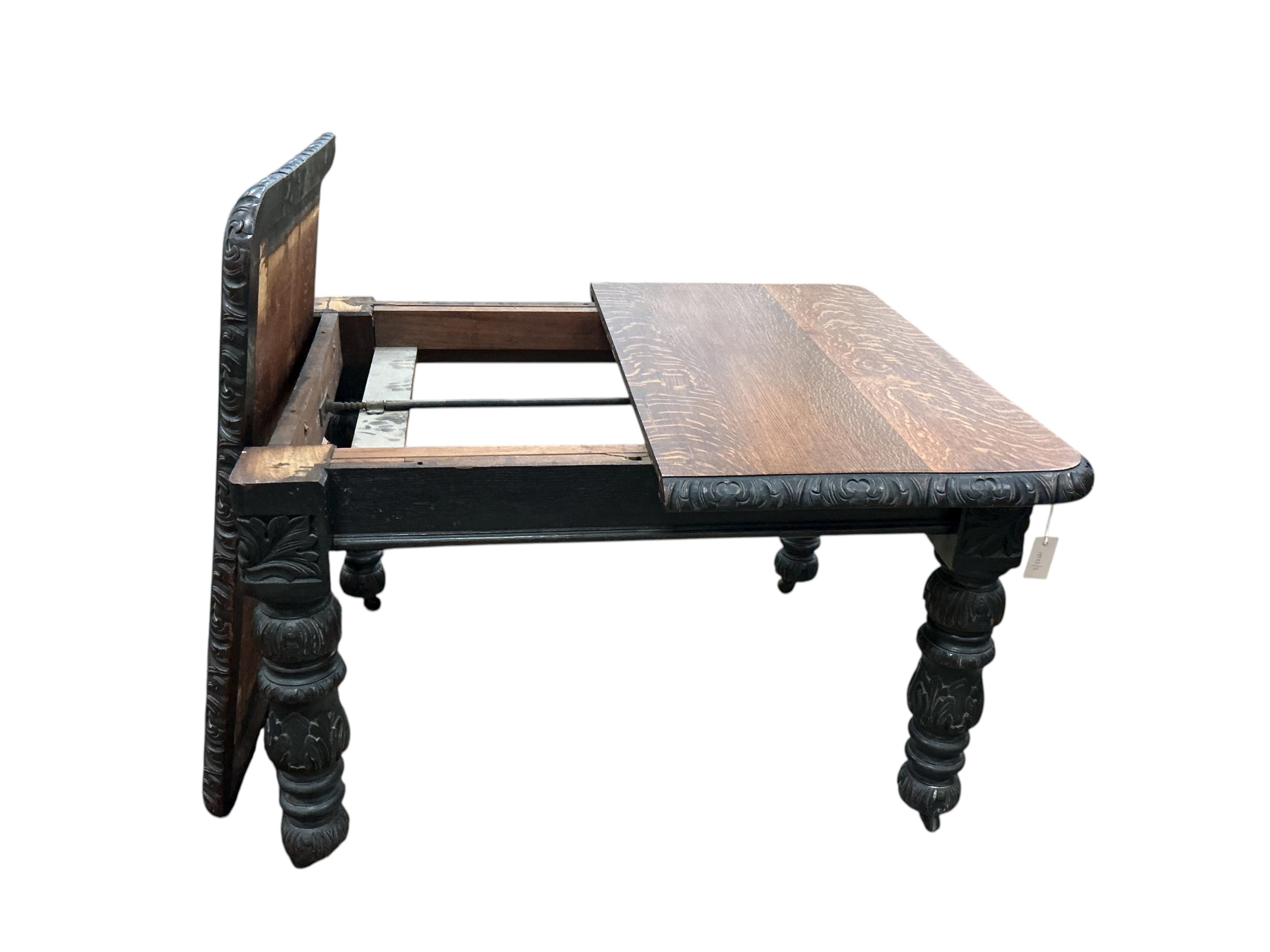 A late Victorian carved oak extending dining table, width 176cm extended, one spare leaf, depth 104cm, height 73cm